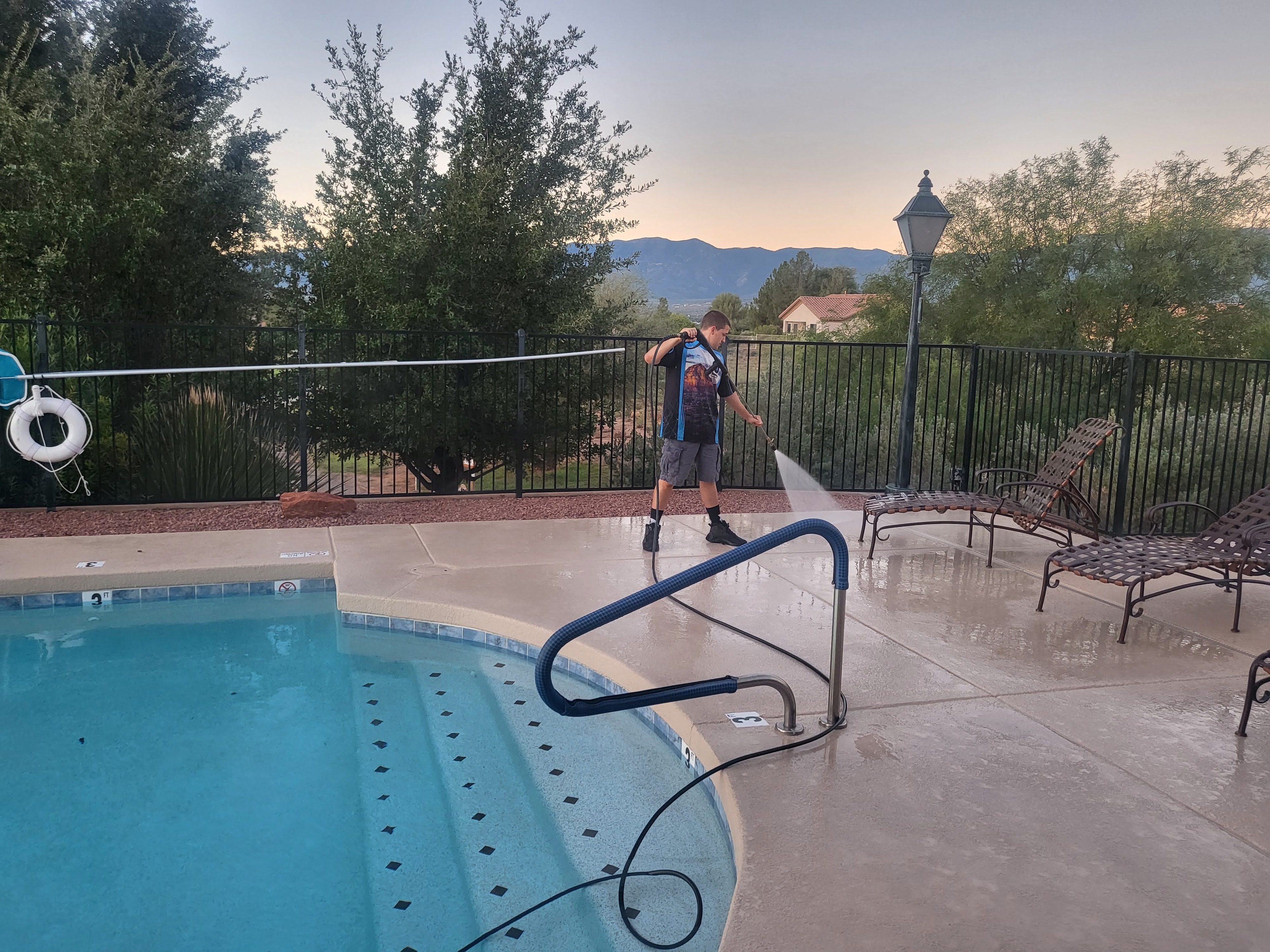 Pressure washing a pool deck at a Cottonwood property with Verde Valley mountains visible in background