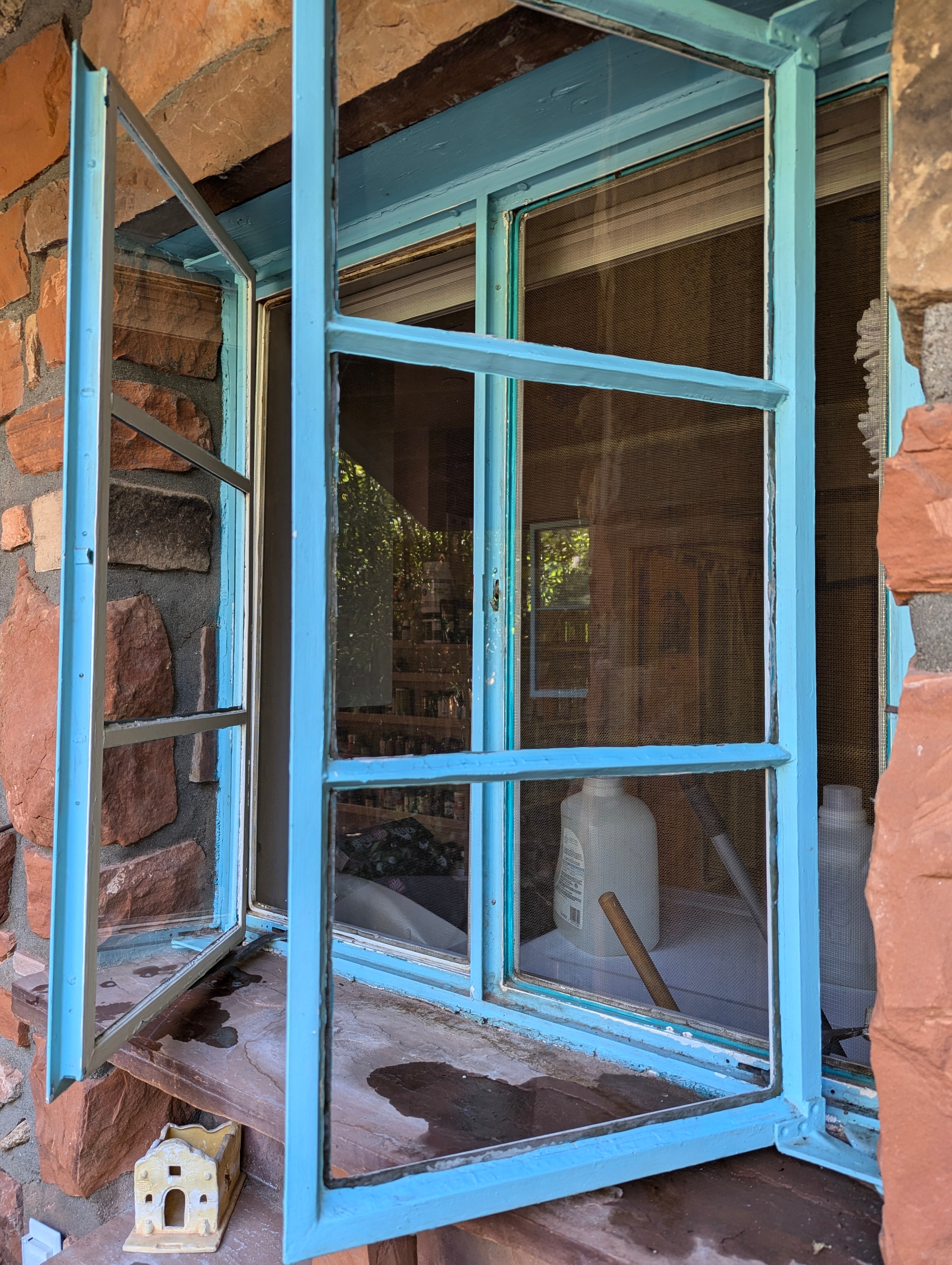 Window cleaning on a blue-framed storefront window in Sedona, Arizona