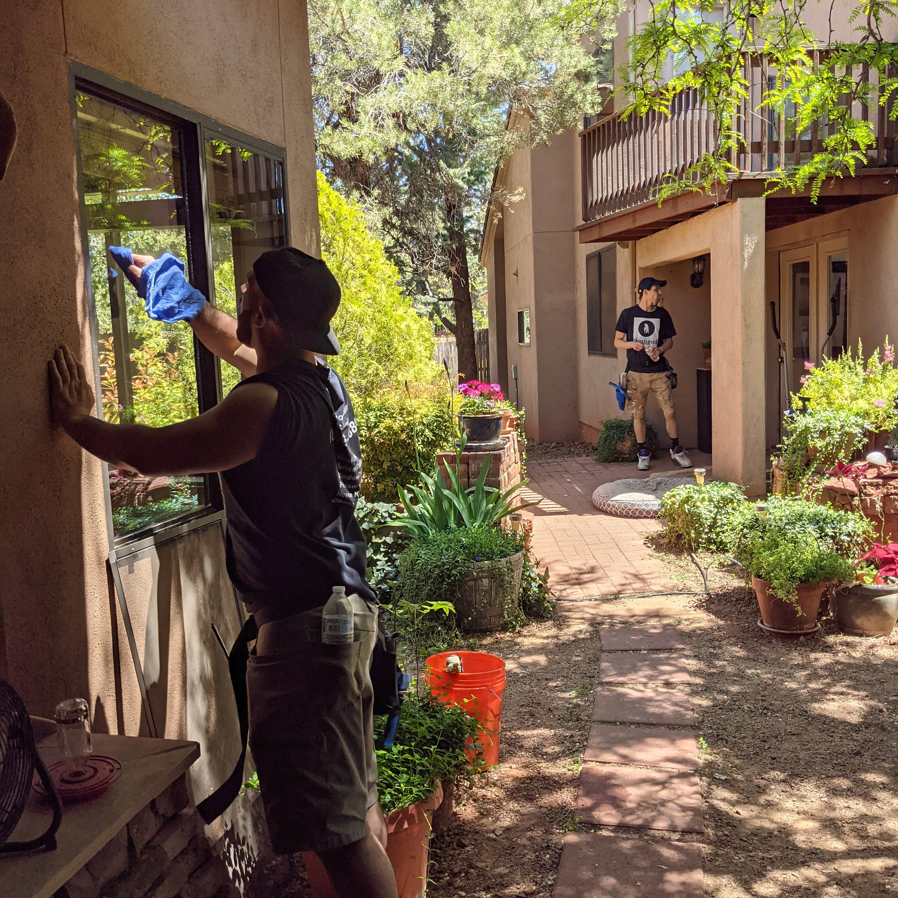 Two-person Demigod window cleaning crew working on a Sedona home courtyard